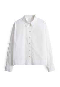 Chemise blanche à manches longues avec boutons, col, coupe slim et détails subtils de broderie sur les manches, présentée sur fond blanc.