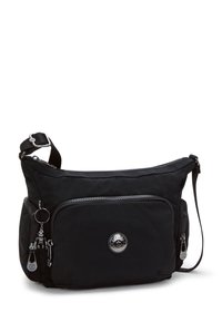 Sort nylon skuldertaske med lynlåslommer, justerbar rem og cirkulært logo detalje. Glat tekstur med sølv hardware accenter.