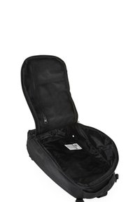 Mochila negra con apertura con cremallera, que cuenta con un bolsillo de malla y un interior de tela suave. Diseño minimalista, sin herrajes ni acentos visibles.