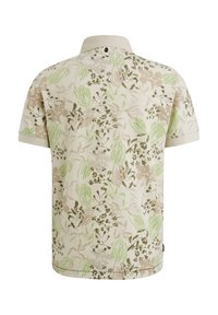 Polo a maniche corte color crema con motivo floreale verde e marrone, dotato di colletto e un piccolo logo sul retro.