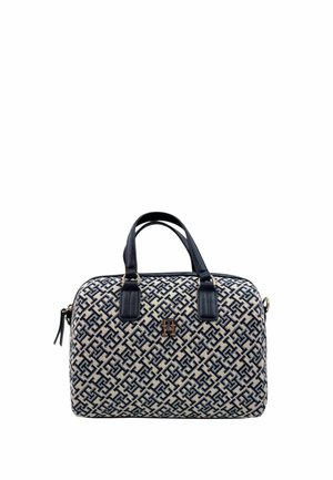 Beige and navy patterned handbag with dual top handles, gold logo plaque, and smooth texture. Features a zip closure and structured shape.