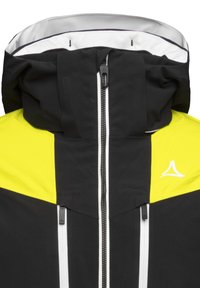 Giacca zip-up nera e gialla brillante con colletto alto, strisce bianche e dettagli con logo. Realizzata in materiale testurizzato e resistente alle intemperie.