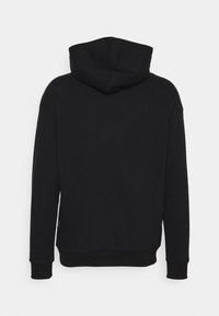 Black hoodie featuring a large hood, ribbed cuffs, and a relaxed fit. Smooth texture with no visible patterns or hardware details.