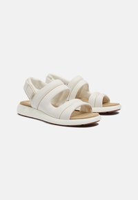 Sandali bianchi con morbidi cinturini in pelle, design open toe, soletta imbottita e suola in gomma flessibile. Presentano accenti di cucitura minima.
