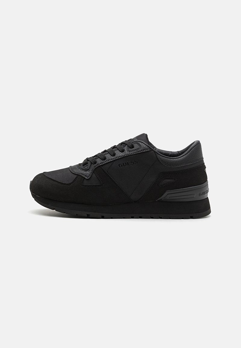 Black athletic shoes with a combination of smooth leather and mesh material, featuring a lace-up design and textured overlays for grip.