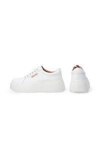 White platform sneakers with a smooth leather exterior, rounded toe, and a rose gold logo accent. Features flat laces and a textured outsole.