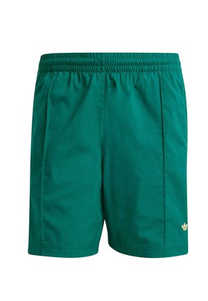 Grønne sports shorts med elastisk talje, to sidelæg og en lille guld logo detalje i nederste højre hjørne. Glat tekstur.