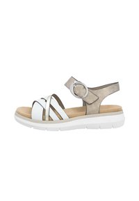 White and metallic sandals with cross straps, a rear strap with a circular accent, cushioned footbed, and white platform sole.