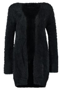 Svart, fluffig cardigan med öppen front, långa ärmar och avslappnad passform. Tillverkad av mjukt, texturerat material för komfort.