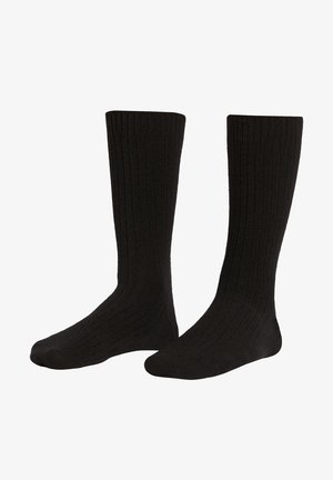 Chaussettes noires montantes avec une texture côtelée et des orteils renforcés. Fabriquées dans un matériau doux pour le confort et la durabilité.