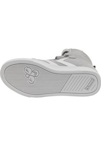 Szara podeszwa sportowego buta z teksturowanej białej gumy, z wzorem w zygzak oraz logo. Górna część lekko widoczna, pokazująca miękki materiał.