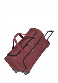 Maroon rolling duffel bag with two front zippers, padded handles, and a retractable handle; features durable fabric and sturdy wheels.