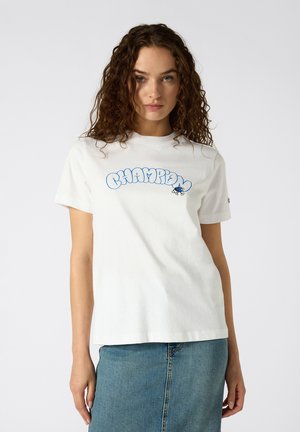 White cotton t-shirt featuring a blue, puffy "CHAMPION" graphic on the front. Short sleeves, relaxed fit, smooth texture.