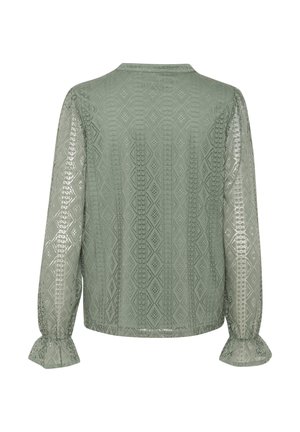 Przezroczysta zielona bluzka z misternym wzorem w diamenty, długimi rękawami i falbaniastymi mankietami. Gładka tekstura z delikatnym połyskiem. Okrągły dekolt.