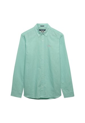 Lysegrøn langærmet skjorte med knapper og knapkrave samt lille broderet logo på venstre bryst.