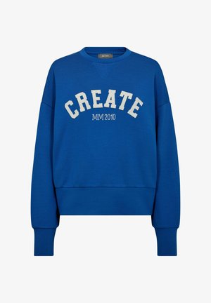 Kék pulóver, kerek nyakkivágással, oversize fazonban, fehér betűkkel a "CREATE" szóval, alatta kisebb szöveggel: "MM 2010".