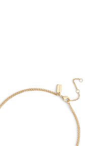 Bracelet chaîne en or avec un design texturé, fermoir mousqueton et longueur réglable avec une étiquette affichant le nom de la marque.