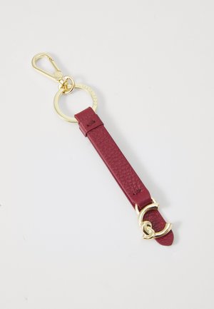 Burgundy leather keychain with a textured strap, gold-tone hardware, and a circular ring attachment. Features a decorative gold accent.