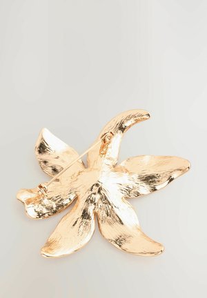 Gold-tone flower brooch with a textured finish, featuring five petals and a secure pin closure. Smooth edges and reflective surface.
