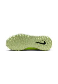 Sole di scarpa sportiva Nike, verde chiaro con superficie texturizzata e motivi circolari. Presenta un logo Nike nero sul lato.