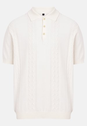 Polo en maille à manches courtes de couleur crème avec motifs en câble et patte de boutonnage trois boutons, taille moyenne indiquée.