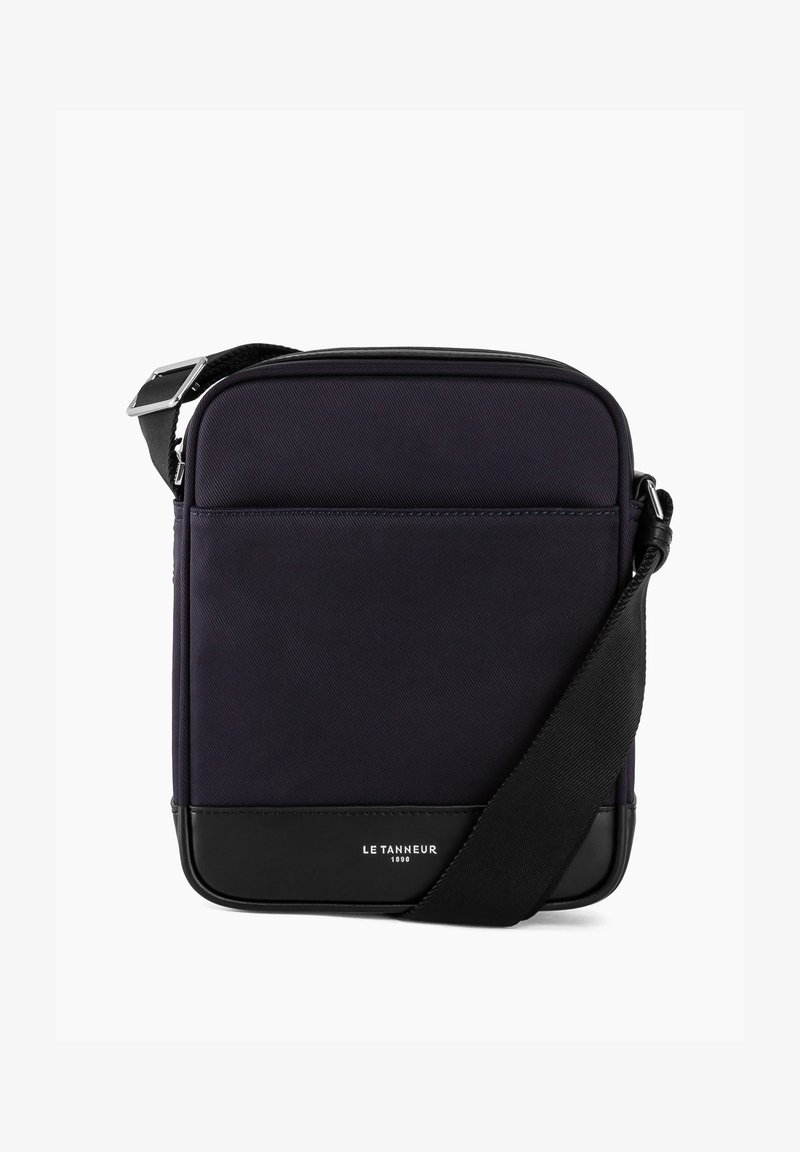 Marineblaues Umhängetasche aus strukturiertem Material mit schwarzen Lederakzenten. Verfügt über eine Vordertasche und einen verstellbaren Riemen, minimalistisches Design.