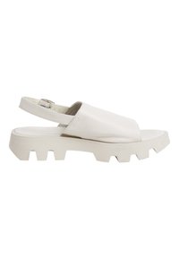 White leather sandal with a chunky, textured sole. Open toe and back strap for secure fit. Designed with a minimalist style.
