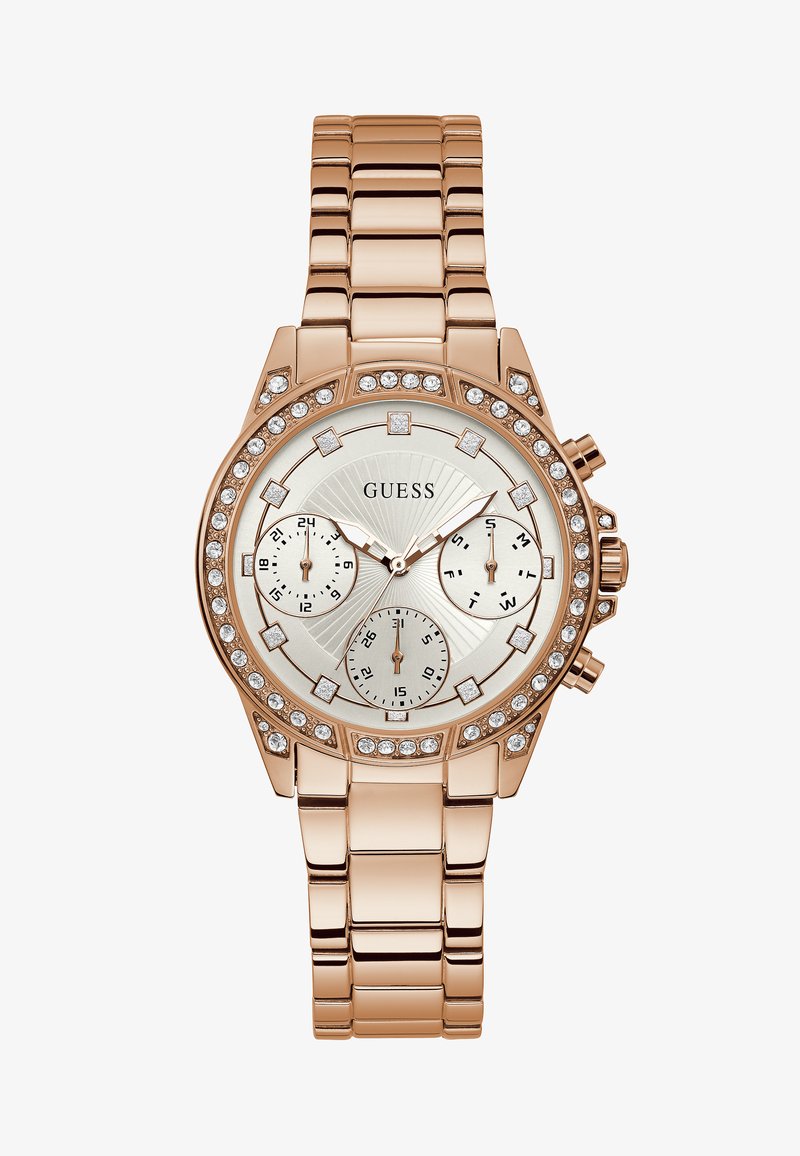 Roségoldene Uhr mit einem Edelstahlarmband, rundem Ziffernblatt, drei Teilzifferblättern und einem mit Kristallen verzierten Lünette um das Ziffernblatt mit Sonnenstrahlenmuster.