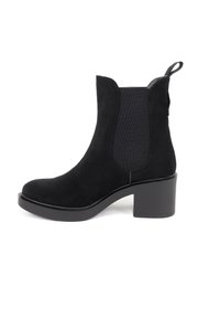 Stivale alla caviglia in suede nero con pannelli laterali elastici, punta arrotondata e tacco spesso. Presenta un'etichetta sul retro per una facile calzata.