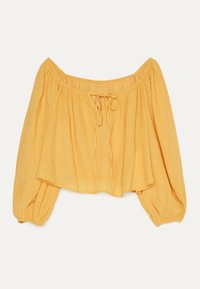 Żółta bluzka na ramiączkach z marszczoną szyją. Posiada szerokie, bufiaste rękawy oraz detal ze sznurkiem z przodu. Wykonana z lekkiego materiału.
