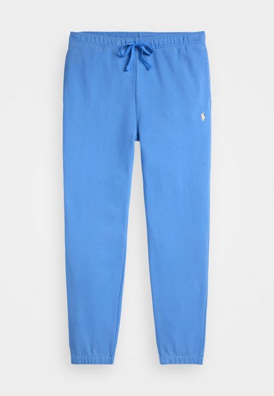 Pantaloni de trening bleu cu talie elastică și șnur de ajustare. Au picioare înguste și un logo mic alb în partea stângă sus.
