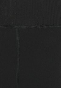 Leggings pretos ajustados com uma textura suave, apresentando uma cintura canelada e costuras planas para conforto e durabilidade.