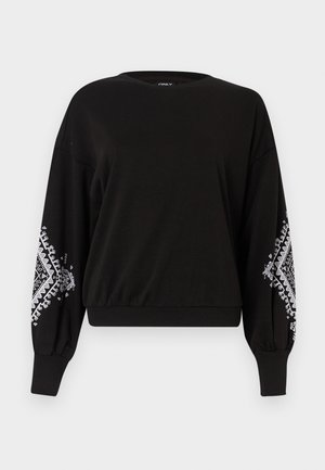 Crna dukserica s okruglim izrezom, dugačkih rukava i bijelim geometrijskim uzorcima na manžetama. Napravljena od mekog, prozračnog materijala.