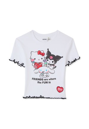 Cropped t-shirt bianca a coste con bordi neri arricciati, con grafica di quattro personaggi dei cartoni animati e la scritta "AMICI sono dove c'è il DIVERTIMENTO."