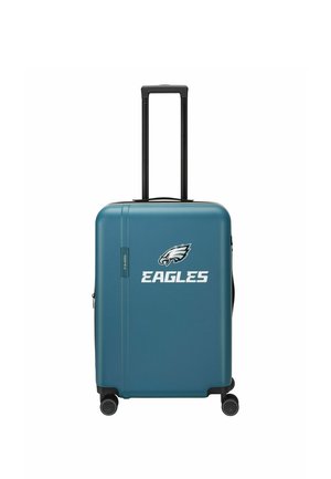 Valigia rigida blu con quattro ruote, manico nero esteso e logo bianco degli Eagles al centro davanti.