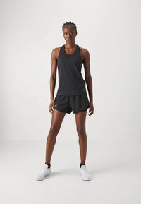 Black athletic tank top and shorts, featuring a sleek design. The fabric is lightweight, with a smooth texture and minimal logo accents.