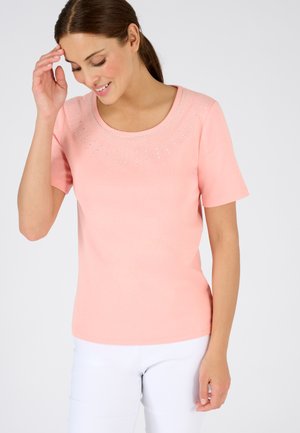 Maglietta corta rosa con maniche corte, caratterizzata da un collo rotondo decorato con un motivo di strass trasparenti sullo sterno.