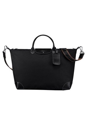 Black fabric tote bag with leather accents, rounded top handles, shoulder strap, and a luggage tag. Features a zipper closure and reinforced corners.