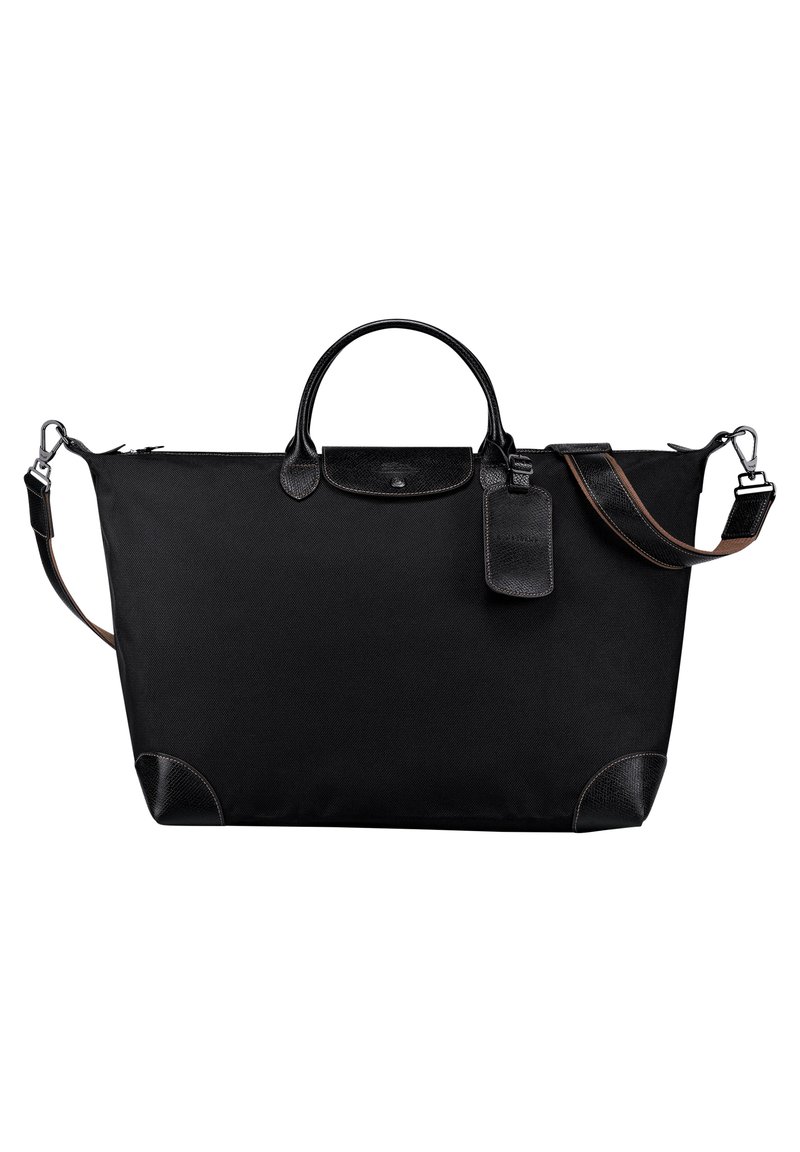 Schwarze Stofftasche mit Lederakzenten, abgerundeten Griffen, Schultergurt und einem Gepäckanhänger. Verfügt über einen Reißverschluss und verstärkte Ecken.