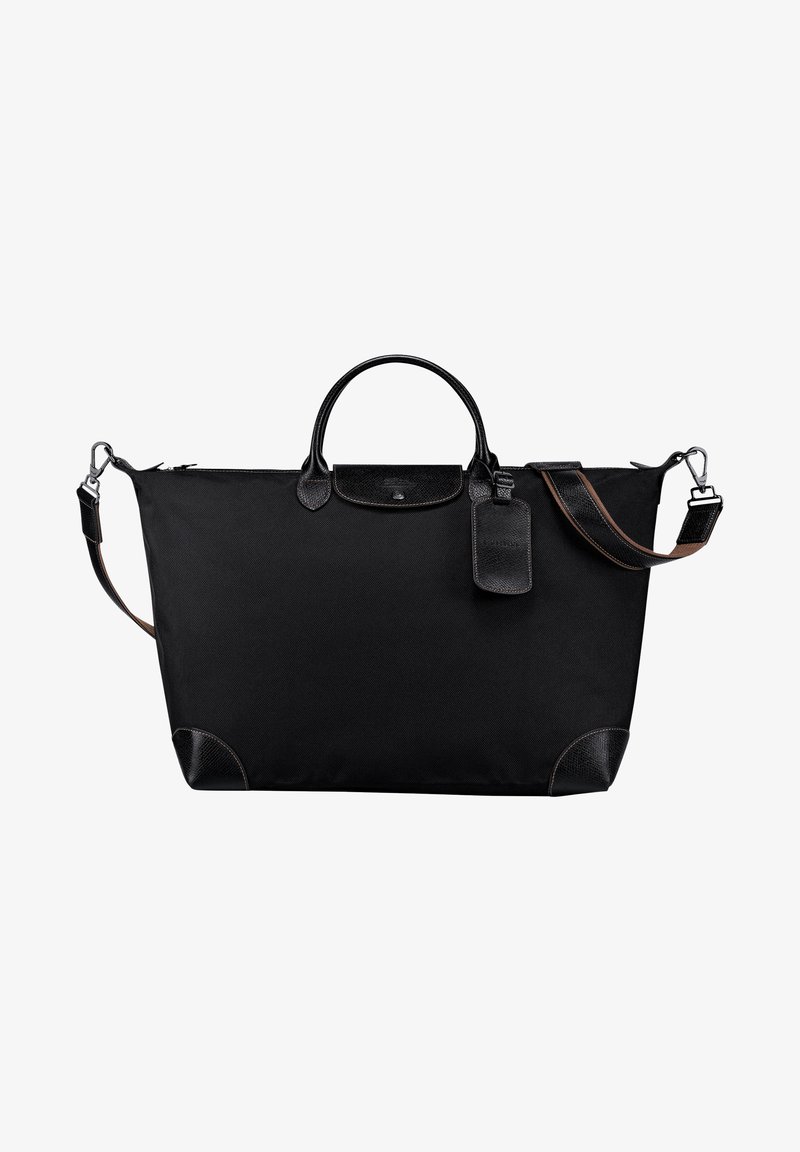 Schwarze Stofftasche mit Lederakzenten, abgerundeten Griffen, Schultergurt und einem Gepäckanhänger. Verfügt über einen Reißverschluss und verstärkte Ecken.