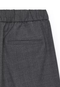 Grey, fabric pants with an elastic waistband and a back pocket. Texture is smooth with a subtle herringbone pattern.