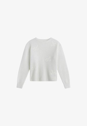 Vit långärmad tröja med diskret blommönster spritt över framsidan och rund halsringning.
