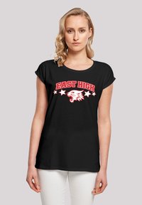 Sort t-shirt med teksten "EAST HIGH" i rød, med en hvid ørne-grafik og fem hvide stjerner i en buet formation over teksten.