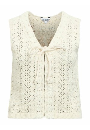 Krémově zbarvená pletená vesta bez rukávů s háčkováním, výstřihem do V a zavazováním vpředu.