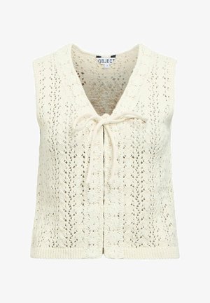 Veste sans manches en maille crochet de couleur crème avec un col en V et une fermeture à nouer sur le devant.