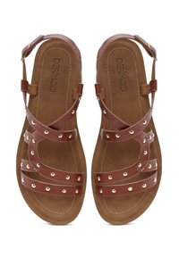 Brown sandal with multiple straps and decorative golden studs. Features cushioned footbed and adjustable ankle strap for secure fit.