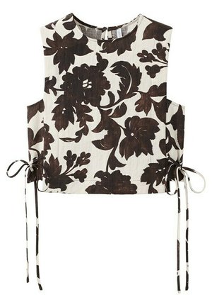 Haut court beige sans manches avec un grand motif floral brun foncé et des liens latéraux à la taille.