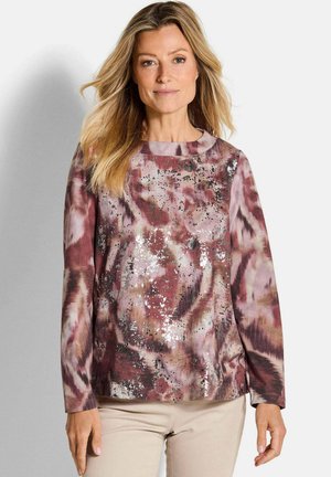 Langärmliges Oberteil in Rosa- und Burgundertönen mit einem Batikmuster und metallischen Akzenten. Rundhalsausschnitt mit lockerer Passform und gerippten Bündchen.