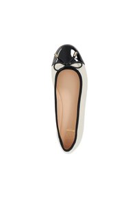 Black patent leather ballet flat with a rounded toe, contrasting cream inner lining, decorative bow, and gold-tone hardware accents.