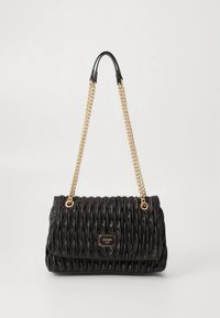 Black quilted handbag made of textured material with a gold chain strap. Features a gold logo plate on the front and a structured shape.